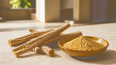Dried mulethi (licorice root) sticks and milled root powder in an amber ceramic dish on a pale stone counter
