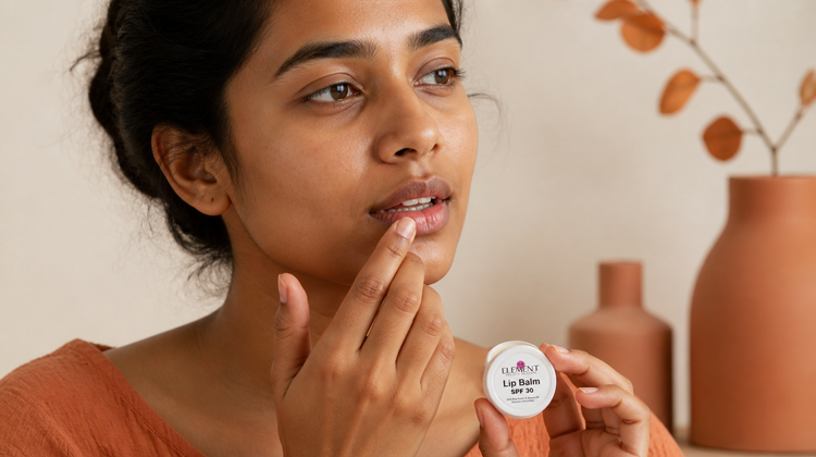 Indian woman with warm brown skin applying The Element Lip Treatment Balm with SPF 30 to naturally deeper-toned lips