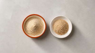Burnt-orange bowl of rice bran powder beside a dish of brown rice grains, natural sources of phytic acid