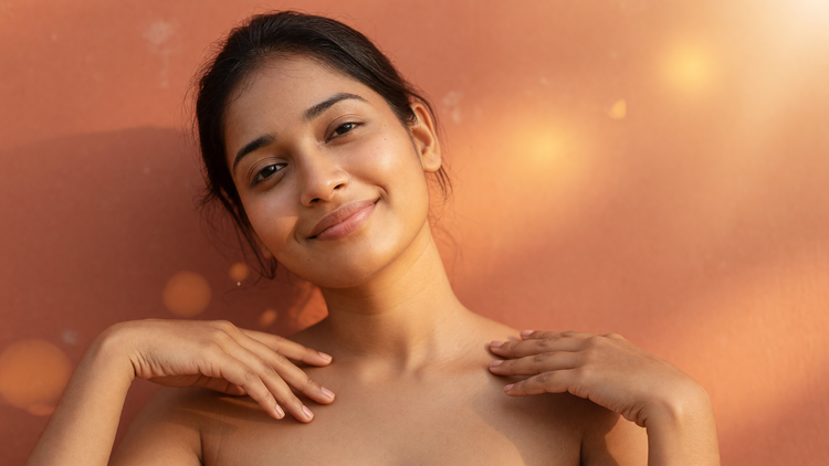 An Indian woman with warm brown skin and a bright, even-toned complexion in warm golden light