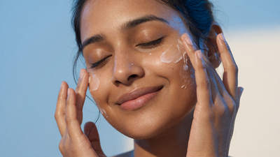 Indian woman patting moisturiser into her face