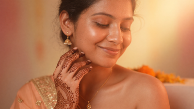 An Indian bride-to-be with warm brown skin and henna on her hands, glowing radiant skin in warm golden light