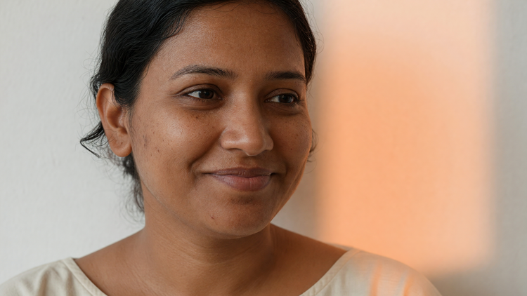 Indian woman with warm brown skin and a clear, even-toned complexion in warm natural light
